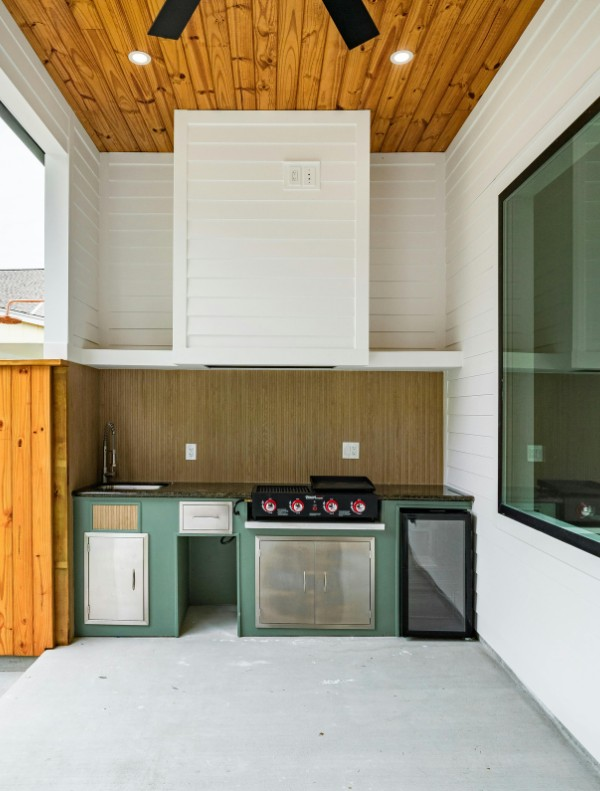outdoor kitchen in the backyard of a home by E2 Remodeling